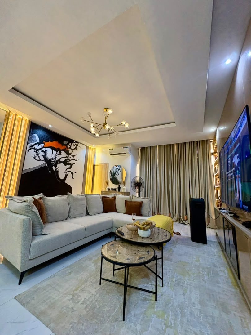 Leona living room with sectional sofa and wall-mounted TV